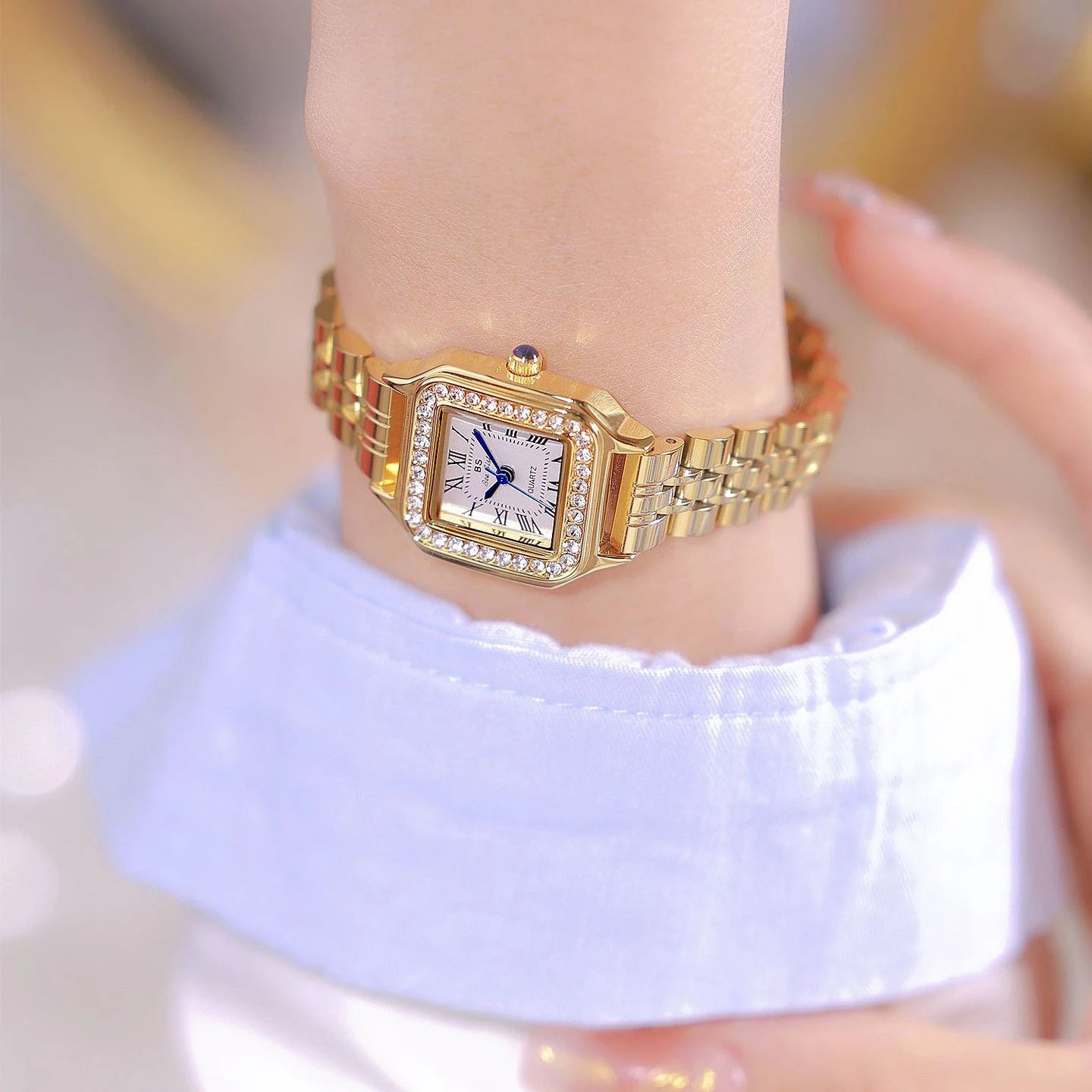 HER GOLD BRACELET WATCH