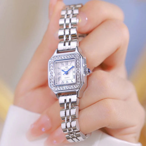 HER GOLD BRACELET WATCH